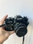 Ricoh XR-2S Slr 35MM Film Camera With Rikenon F2 50MM Lens, Strap, And Cap. Fixed Price $89.99.
